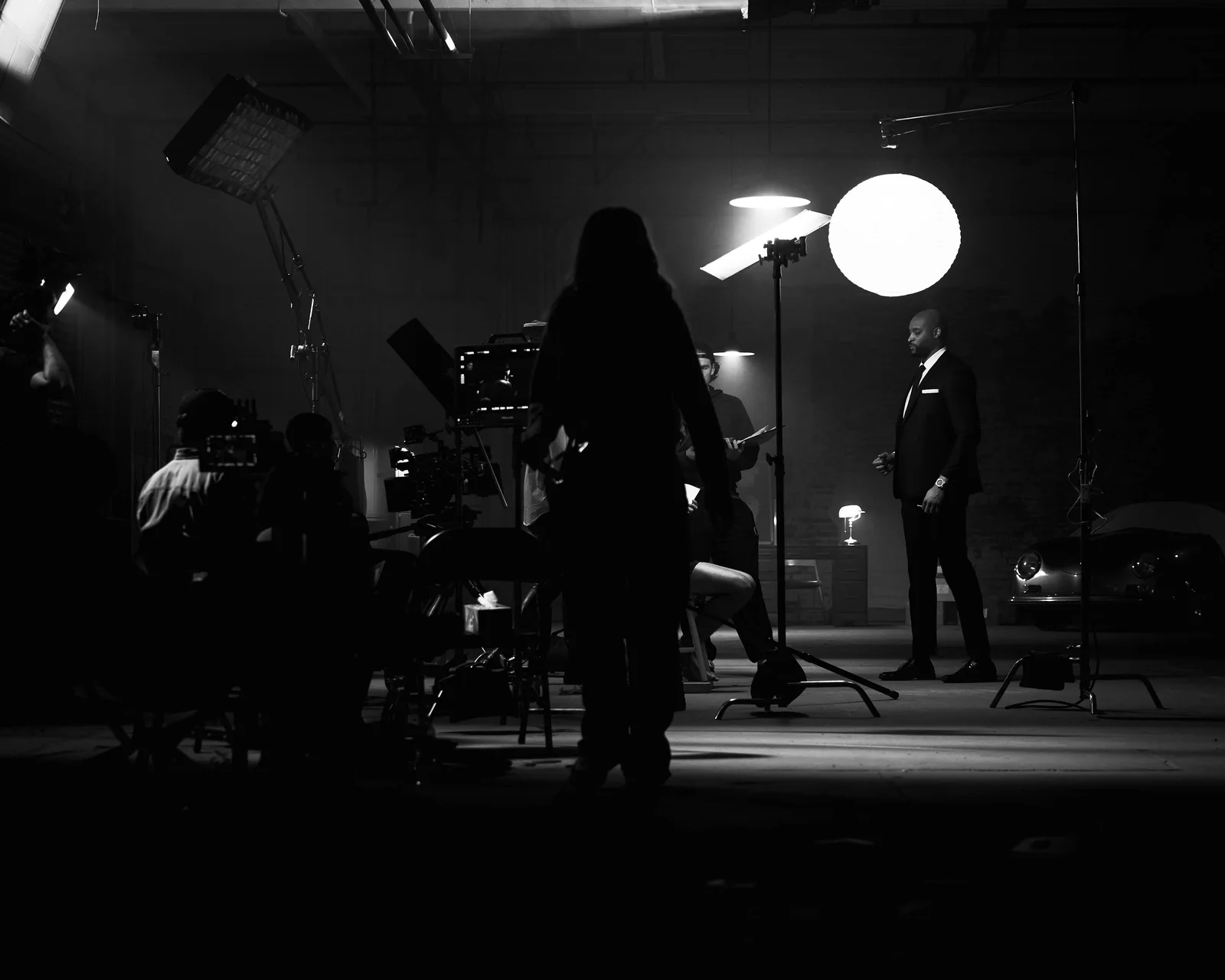 Crew preparing a camera setup beneath overhead diffusion. The Hitman’s Dalliance.