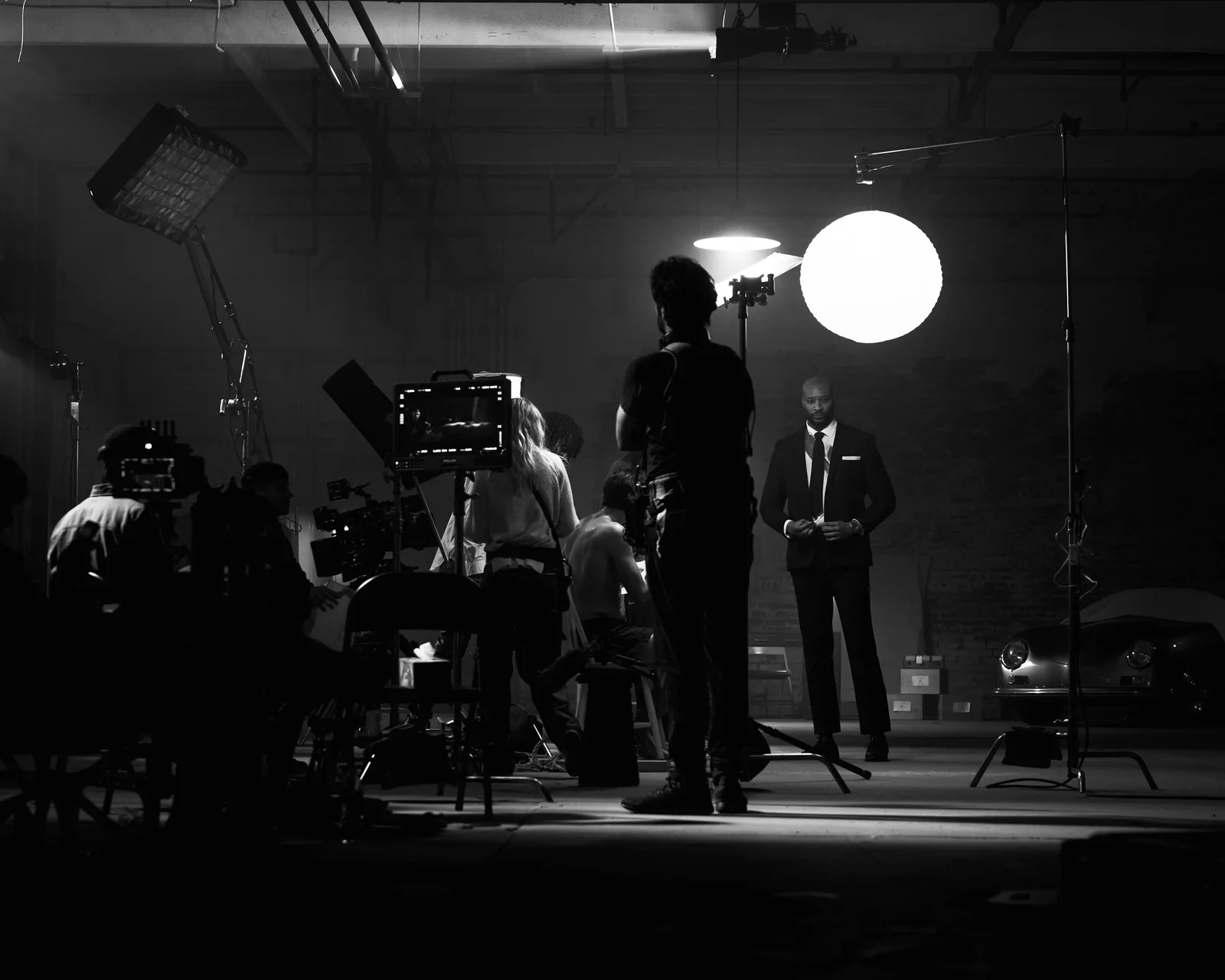 Black-and-white view of the camera crew and actors on the warehouse set. The Hitman’s Dalliance.
