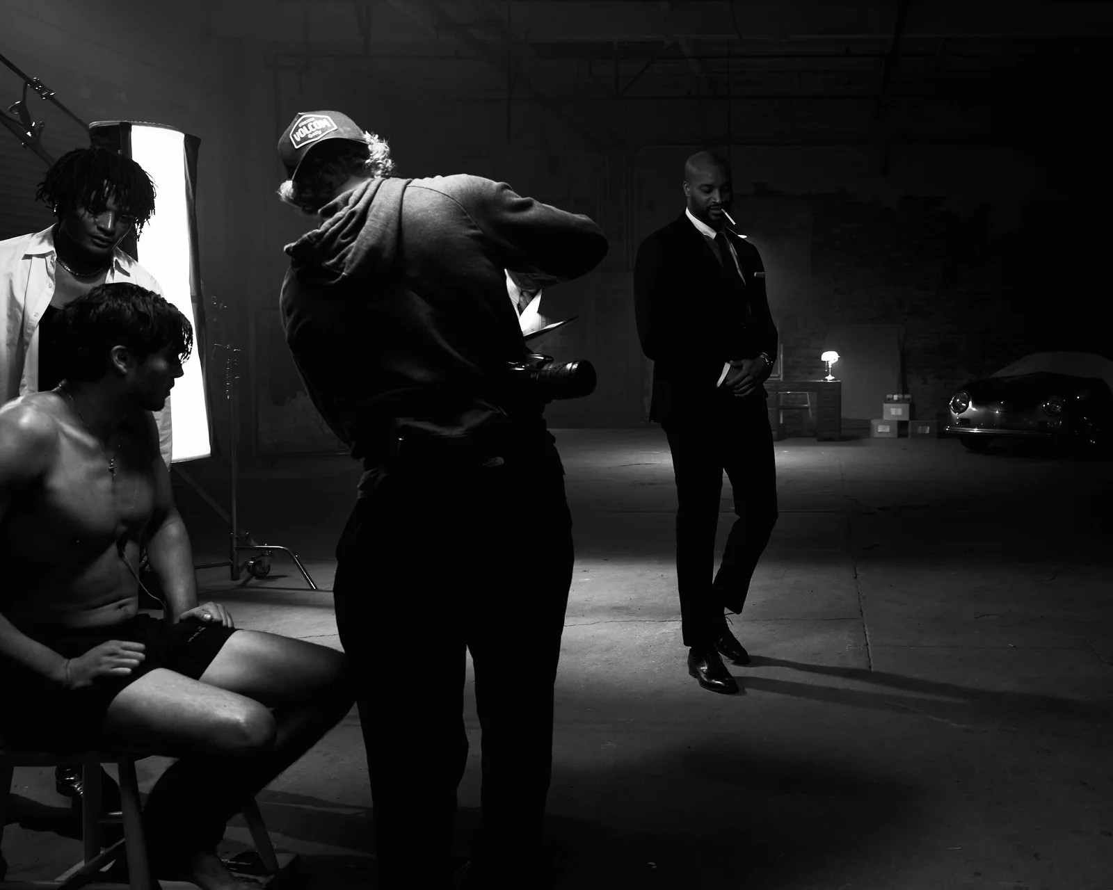 A crew member giving direction beside a seated actor. The Hitman’s Dalliance.