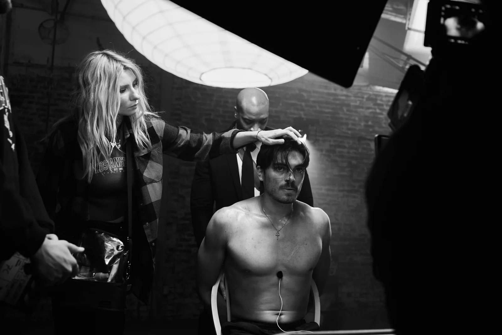 Hair and makeup adjustment for a seated actor between takes. The Hitman’s Dalliance.