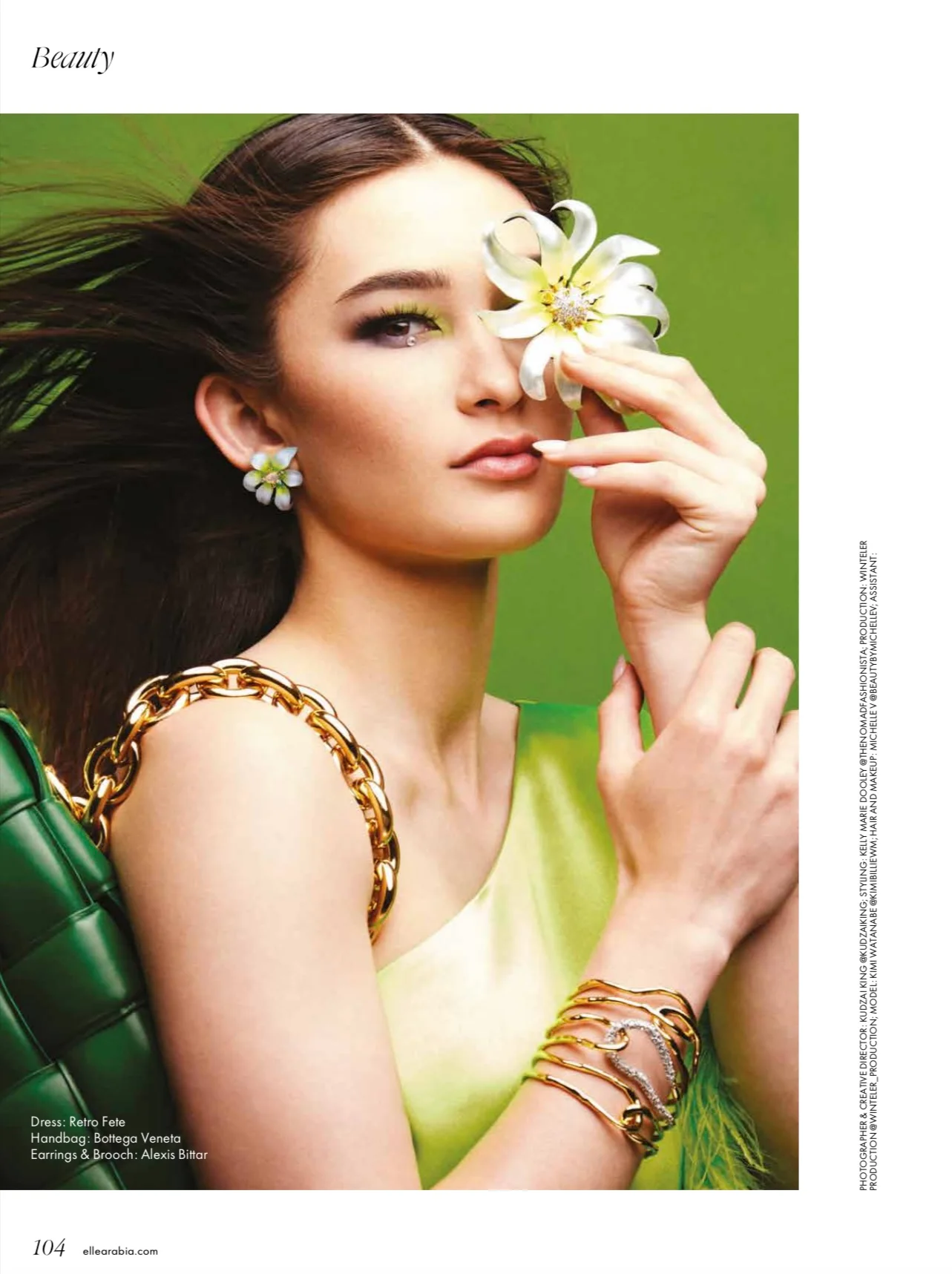 ELLE Arabia page 104: a beauty portrait with a white flower, green background and printed credits.