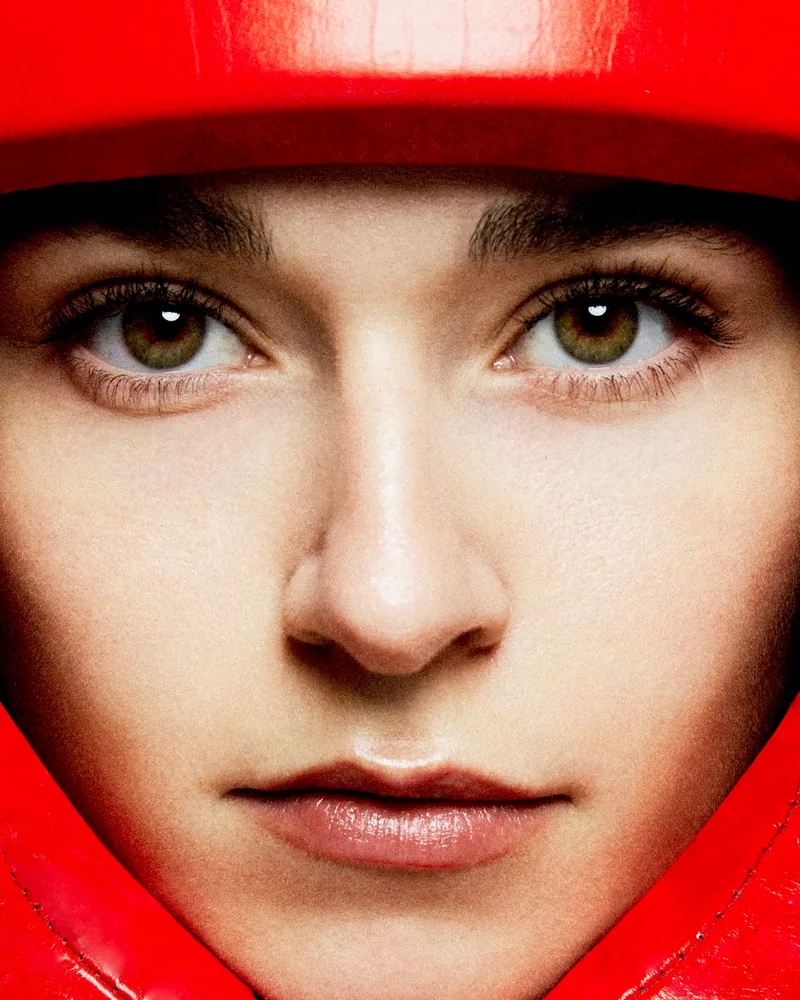 A close beauty portrait framed by bright red fabric.